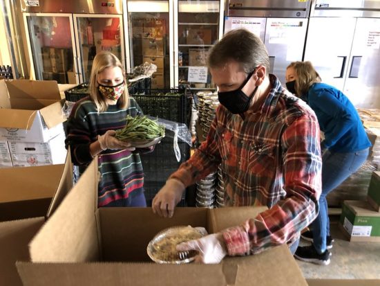 Re:Vision volunteers pack holiday food