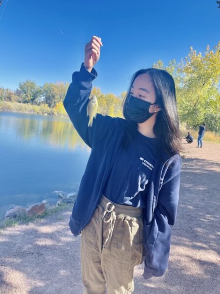 A student catching a fish at Lake Lehow!