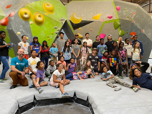 A group of students at the climbing gym. 