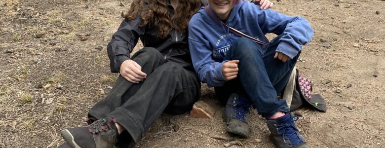 Two students who have successfully built a small fire