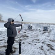 AXL student learning archery