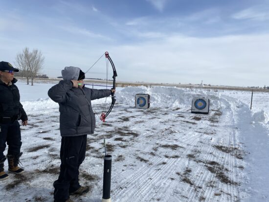 AXL student learning archery