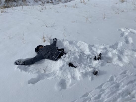 AXL student making a snow angel