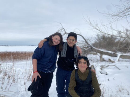 Three AXL students playing in the snow