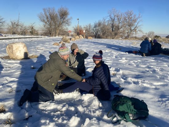 Winter training with Global Emergency Medics. Two instructors treat a patient.