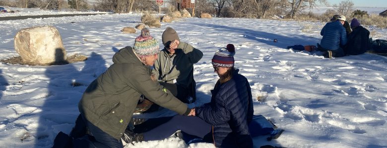 Winter training with Global Emergency Medics. Two instructors treat a patient.