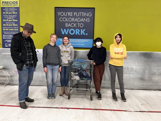 Changemakers standing outside a thrift store. 