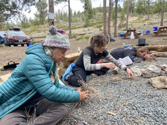 Instructors building small fires at staff training