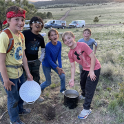 Littleton Academy students pose while cooking dinner