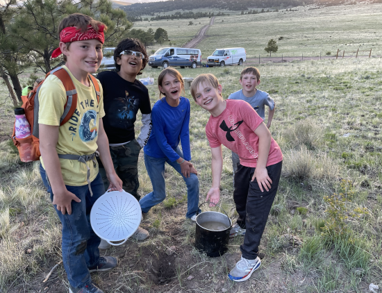 Littleton Academy students pose while cooking dinner