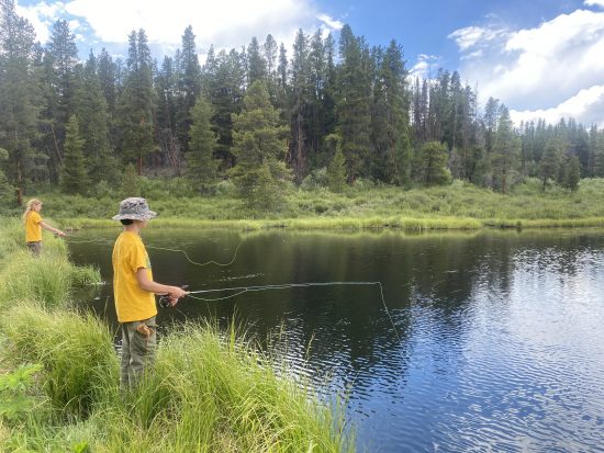 Two students fish on the Outward Bound campus.