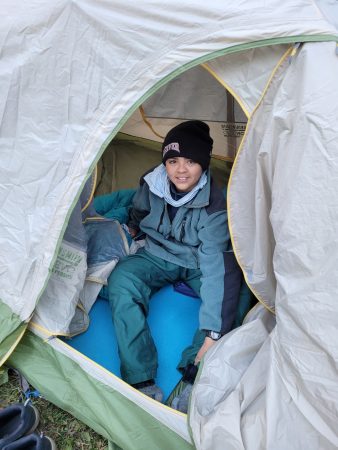 Centaurus High School student in a tent