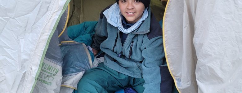 Centaurus High School student in a tent