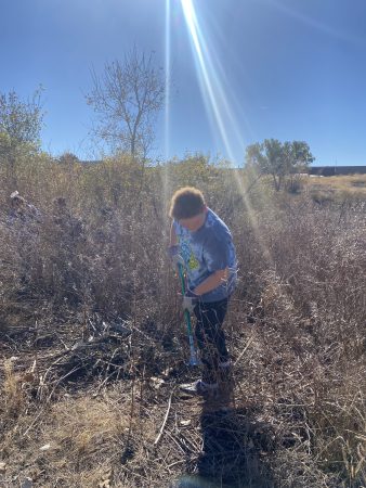 AXL student picking up trash