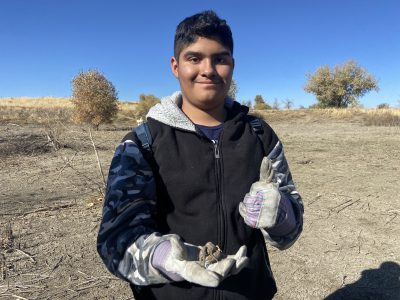 AXL student picking up trash