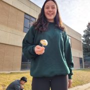 A Centaurus High School student roasts a marshmallow on a fire they built with their class