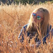 A Changemaker student sitting in a peaceful meadow