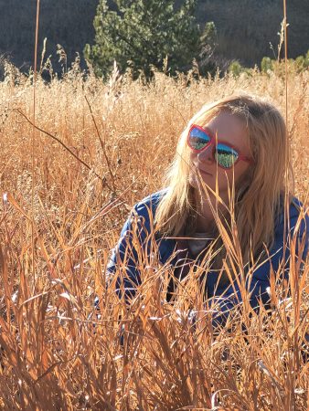 A Changemaker student sitting in a peaceful meadow