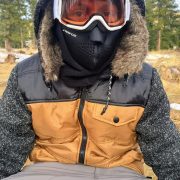 An AXL Academy 8th grader poses in snow gear: a hat, goggles, and face mask