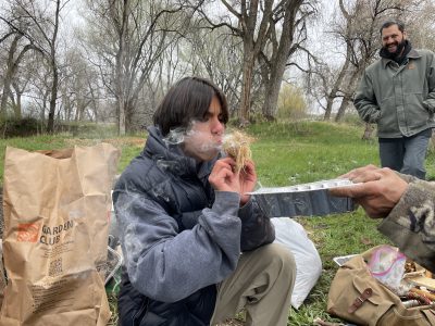 A Changemaker student practices ancestral skills at the ancestral skills gathering at Ollin Farms