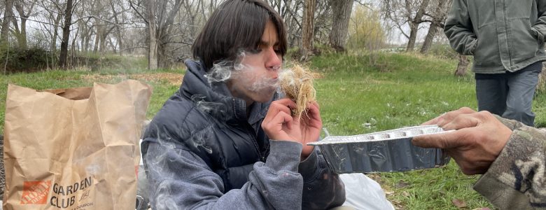 A Changemaker student practices ancestral skills at the ancestral skills gathering at Ollin Farms