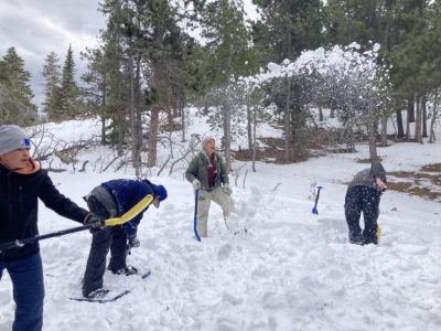 Students fling snow at eachother while creating a snow pile for the base of their shelter. (Shira Nathan)