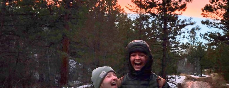 Two alums enjoy a laugh along the trail on the solstice hike.