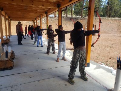 AXL Academy students enjoy trying archery on their overnight trip.