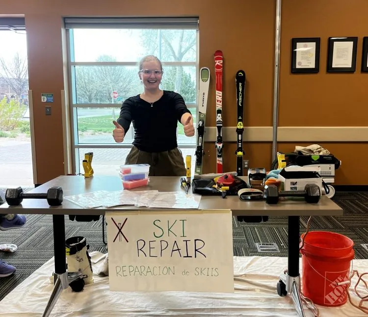 A Changemaker student displays tools for ski repair during the gear repair workshop.