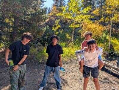 AMS CAP student enjoy hanging out near the fall foliage on their overnight trip.