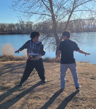 Two Lafayette Explore Outside participants play an active game where they pretend to be different kinds of birds.