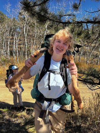 One Changemaker student holds up the deer legs that were found during their Taylor Mountain backpacking trip.