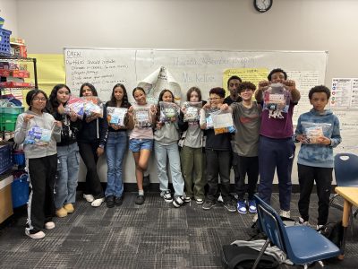 AXL CAP students show off their community care kit packages that they created for their action project.