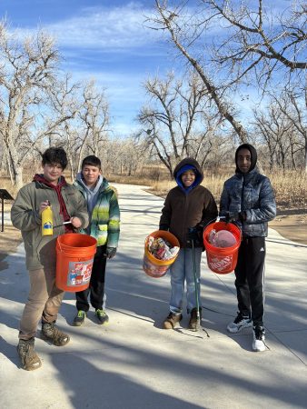 AXL 7th grade students show off the buckets of trash they picked up at Cherry Creek State Park.