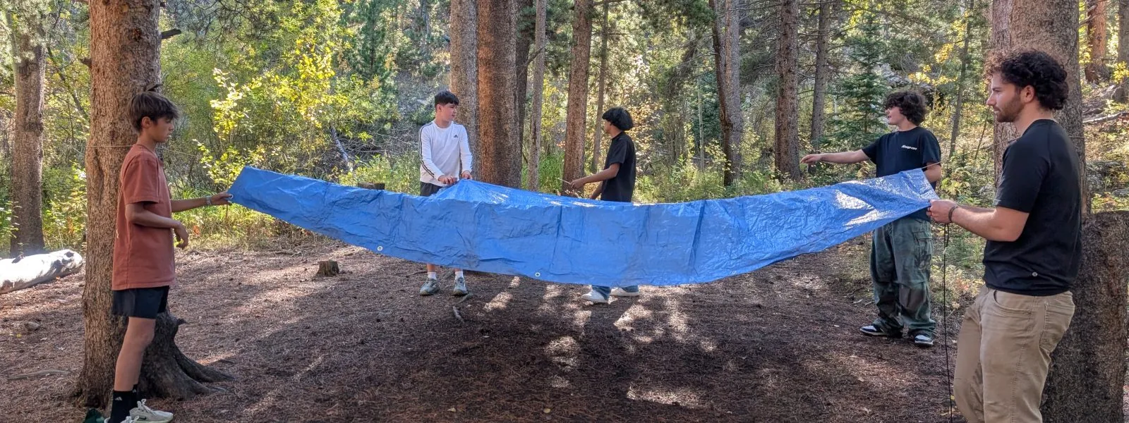 Angevine students set up a tarp during their overnight CAP trip.