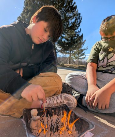 Two Angevine students set fire to their "matchstick forest" as they explore various aspects of fire.