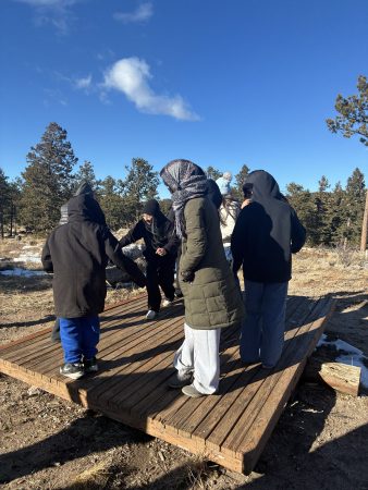 AXL students stand on a low ropes element during their Cal-Wood overnight trip.