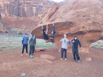 Members of the Big Blue Booty Bears enjoy some moments of backcountry magic and time with backpacks off while exploring and hanging on some huge rocks in the canyon.