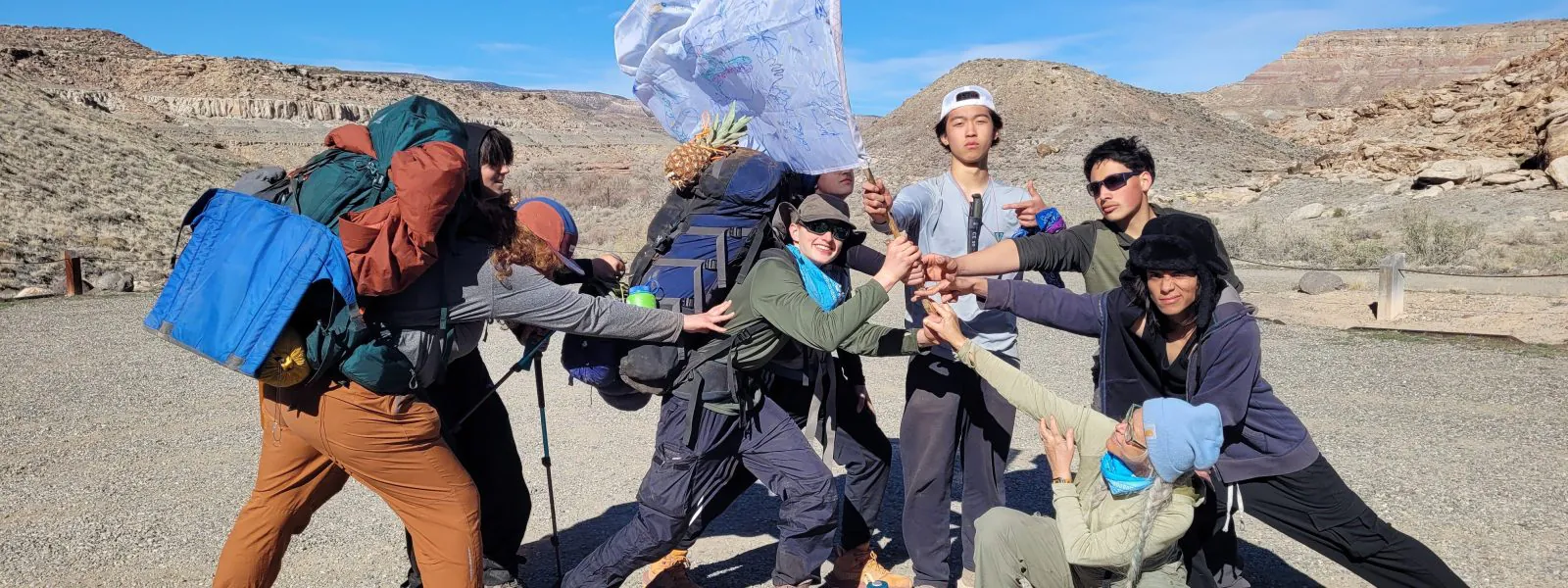 The Big Blue Booty Bears gather to hold high their homemade team flag.