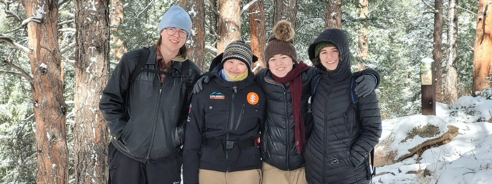 Changemakers Alumni pose outdoors during their snowy spring break hike.