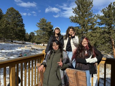 Four AXL students pose on the deck of a cabin at Cal-Wood during their winter overnight CAP trip.