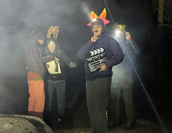 Cottonwood Instructors in silly costumes prepare to do a skit at night during staff training.
