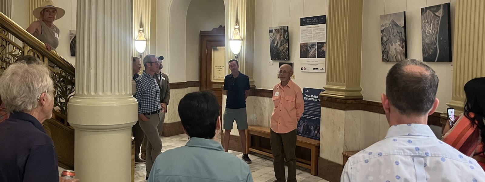 Artist Mike Wilson talks about Colorado 14ers with attendees at the reception at the Colorado State Capitol.