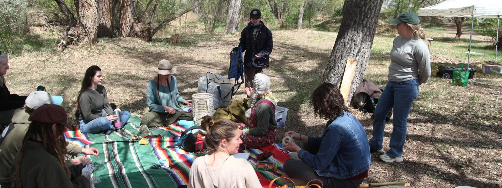 People at the Ancestral Skills Gathering 2026 learn how to make baskets.