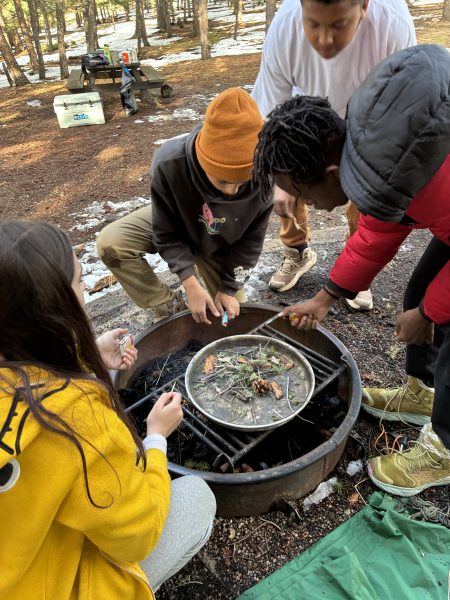 AXL student practice making a campfire using materials found at their (wet) campsite.