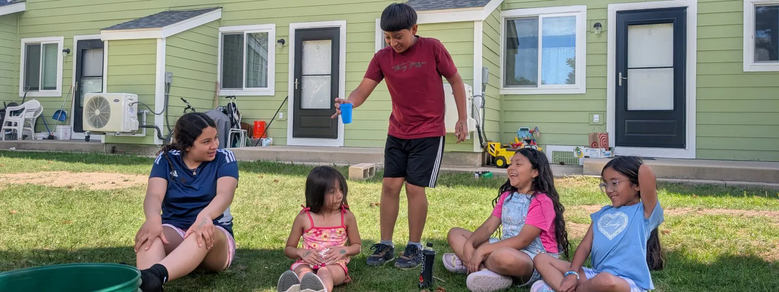 Casa teens play a game of Drip, Drip, Drop with younger students during their backyard overnight.