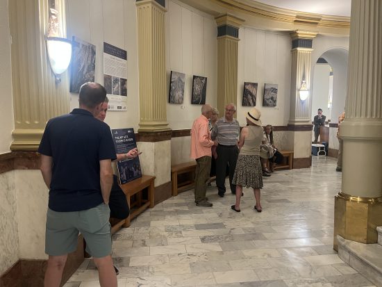 Attendees of the Colorado 14ers artwork reception mingle at the rotunda at the Colorado State Capitol.