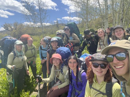 All Changemakers participants pose for a selfie with their backpacking packs on.