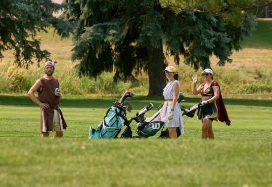 The team called "Odyssey My Putt" poses for a photo on the green during the 2026 Golf Invitational.