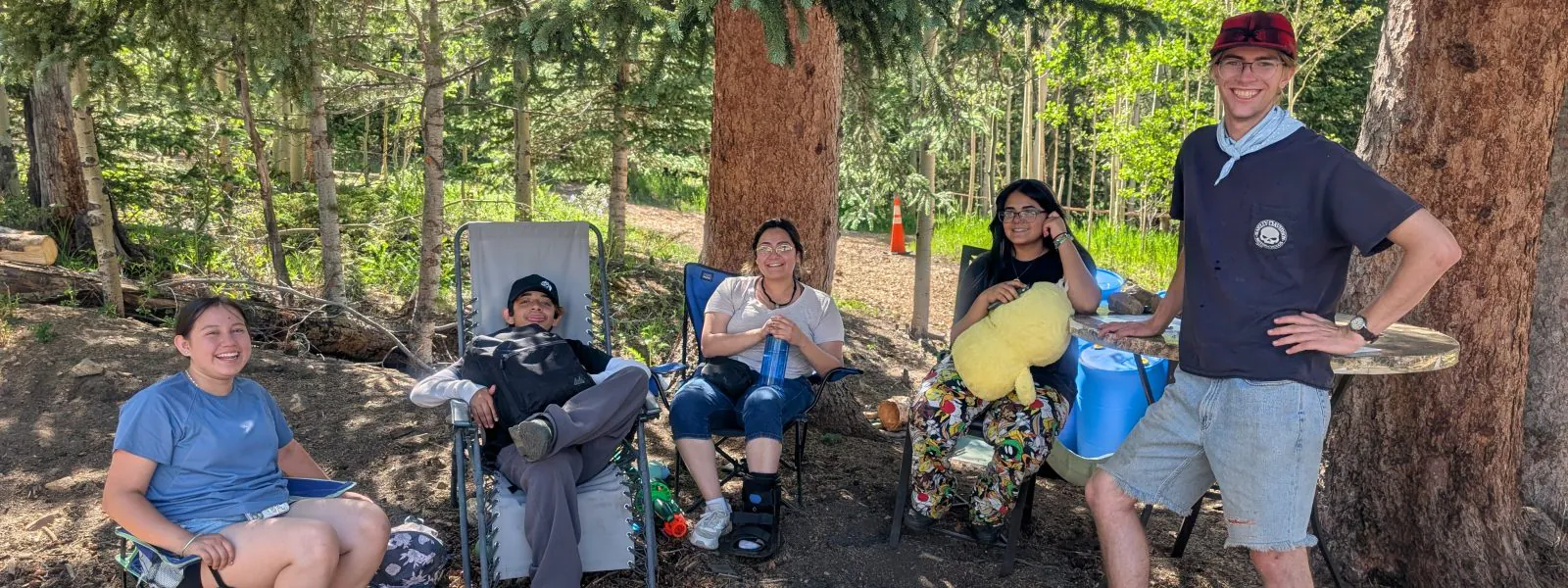 Casa family camping participants lounge around the campsite.